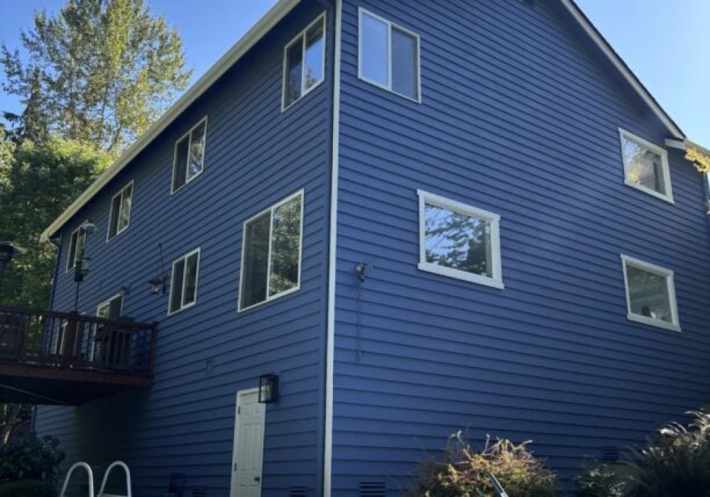 Blue house exterior with empty above-ground pool