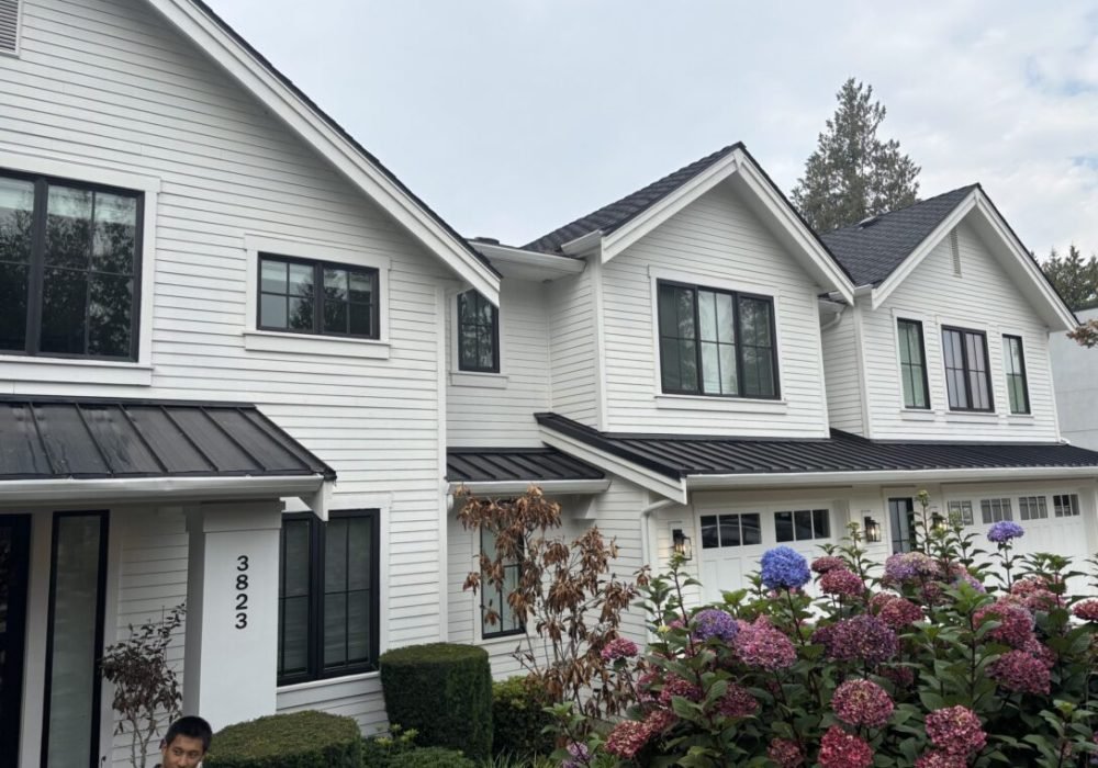 White modern house with colorful blooming hydrangeas